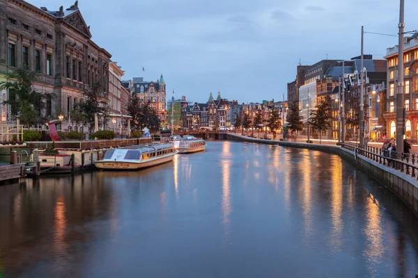 Amsterdam, Netherlands - October 14, 2019: Famous landscape in Amsterdam with unique building at night