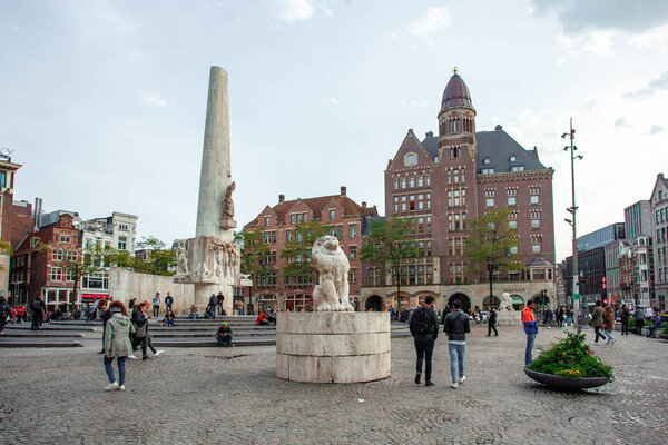 Amsterdam, Netherlands - October 14, 2019: Stone lion as part of The National Monument on Dam Square in center of Amsterdam