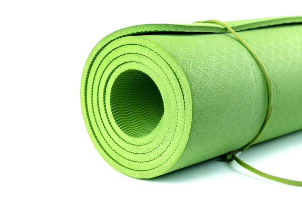 Green rolled sleeping mat isolated on white background. Sport equipment