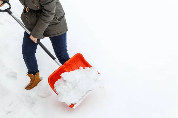 Жінка з лопатою прибирає зимовий сніг . — стокове фото
