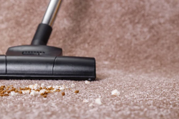 Vacuuming carpet with vacuum cleaner. Housework.