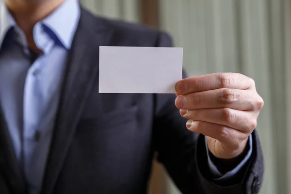 Businessman holding visit or business card. — Stock Photo, Image