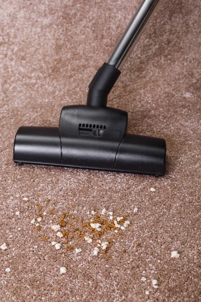 Vacuuming carpet with vacuum cleaner. Housework.