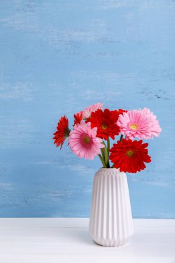 Ahşap arka plan üzerinde Vazoda Çiçekler gerbera.