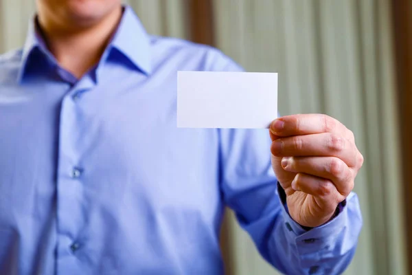 Man holding visit or business card.
