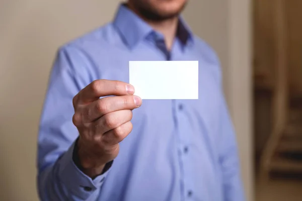 Man holding visit or business card.