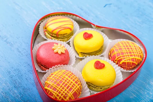 Macaroon cakes. Heart-shaped delivery box.