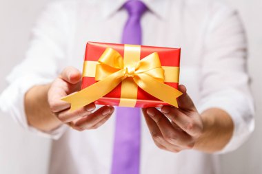 Kurdele ile bir kırmızı hediye kutusu holding erkek eller.