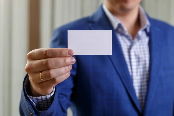 Businessman holding visit or business card.