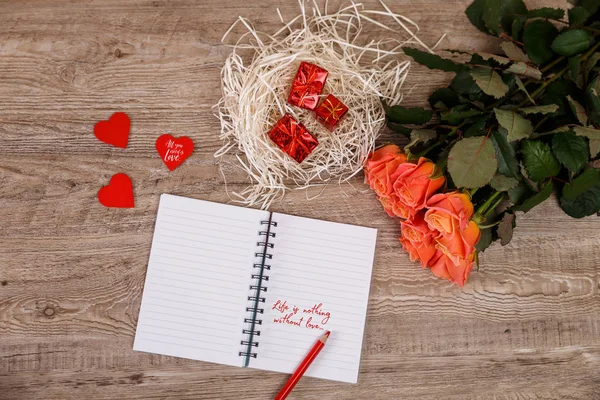 Pink roses with heart, gift boxes and notebook. — Stock Photo, Image