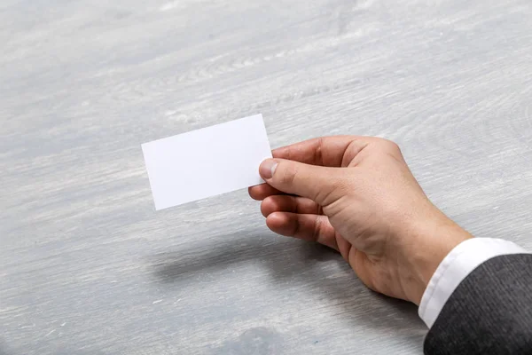 Hand hold blank business card design mockup.