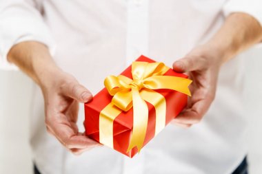 Kurdele ile bir kırmızı hediye kutusu holding erkek eller.