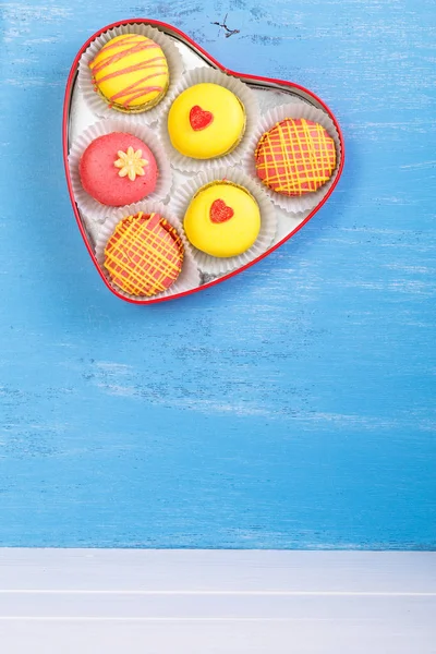 Macaroon cakes. Heart-shaped delivery box.