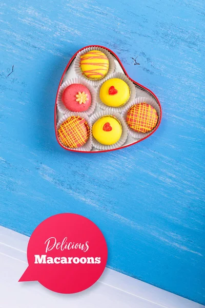 Macaroon cakes. Heart-shaped delivery box.