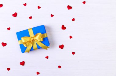 Hediye kutusu ile kırmızı kalpler. Mavi geçerli paketin.