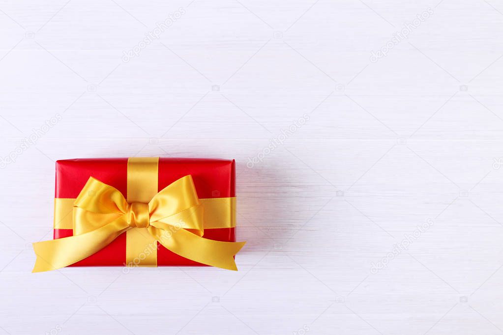 Gift box with yellow bow. Red present package.