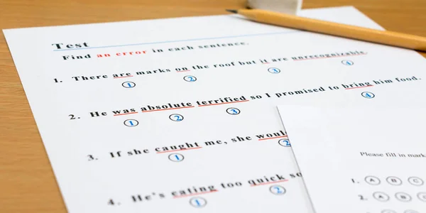 English test and answer sheet on table — стоковое фото