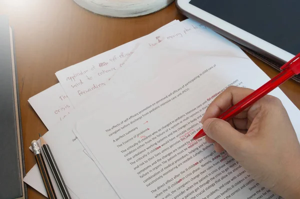 Proofreading paper on wooden desk — Stock Photo, Image