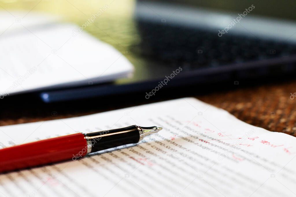 pen on paper on desk in office