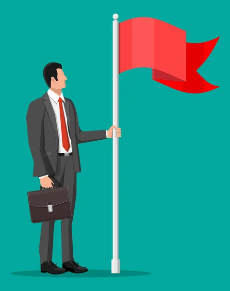 Businessman in suit standing with flag — 스톡 벡터