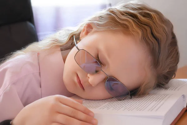 Cute girl sleep on book