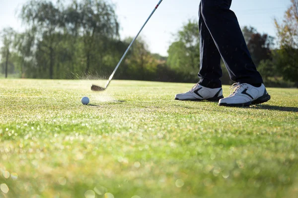 Golfer hitting iron club on golf course on fairway. — Stock Photo, Image