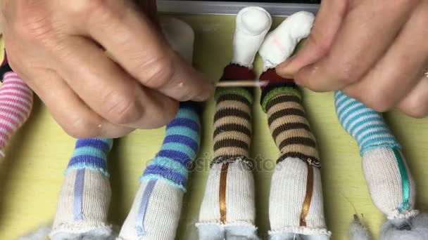 Master puppeteer makes shoes and clothes for dolls. — Stock Video