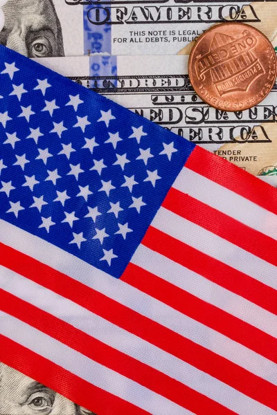 The American flag covers one hundred US dollars. And one America