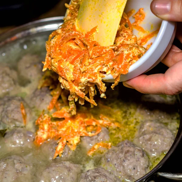 Preparation of homemade soup with meatballs and vegetables in a — Stock Photo, Image