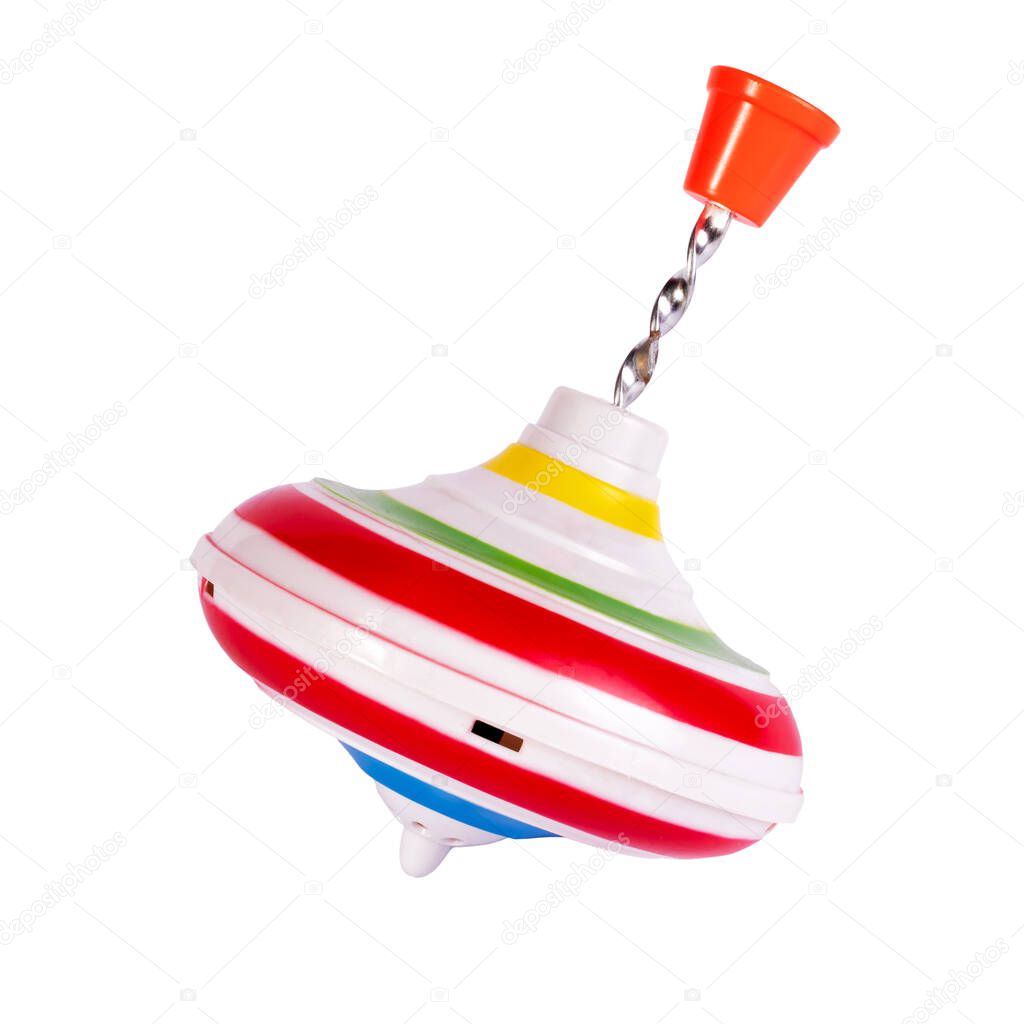 Multicolored plastic spinning top or whirligig top is traditional toy for preschool childs.Boys and girls with pleasure watching them spin. Isolated on white. Close-up.