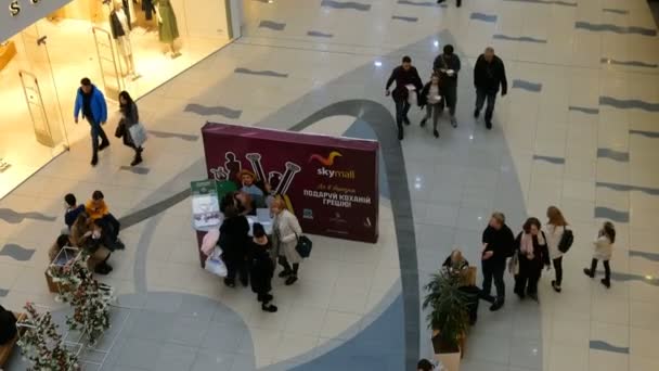 Kiev, Ucrânia, fevereiro 2020: - Venda, consumismo e pessoas. Interior do shopping moderno. Muitas pessoas não identificadas caminham e relaxam no moderno supermercado Sky Mall em Kiev, Ucrânia. Vista superior . — Vídeo de Stock