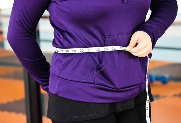 Lose Weight Concept, The Woman is Measuring Her Waist