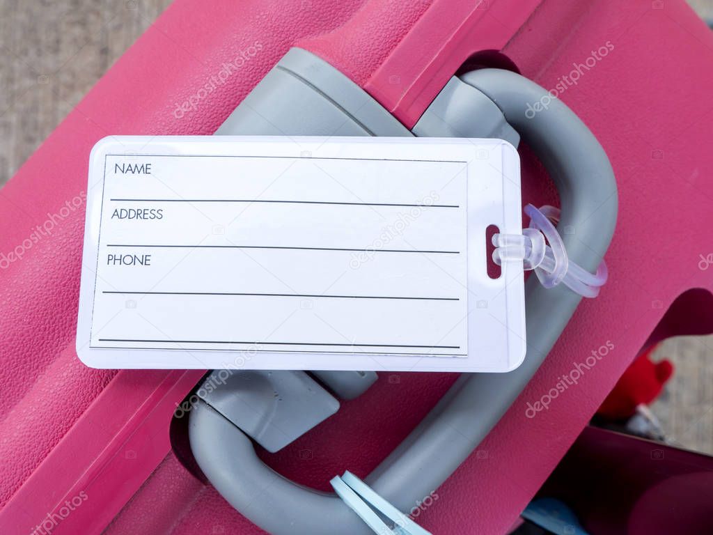 Luggage tag on pink suitcase 2
