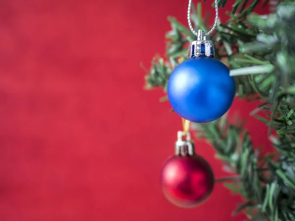 Balle de Noël bleue et rouge accrochée au sapin de Noël avec flou rouge — Photo