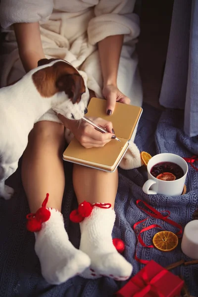 Female foots and cup of christmas tea