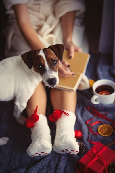 Female foots and cup of christmas tea