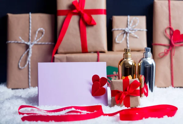 Gift boxes and perfume with envelope — Stock Photo, Image