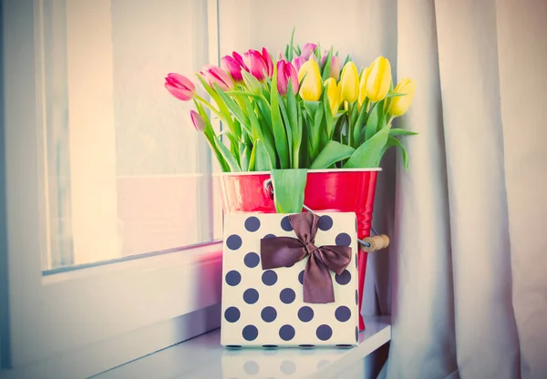 Tulipanes en cubo y regalo —  Fotos de Stock