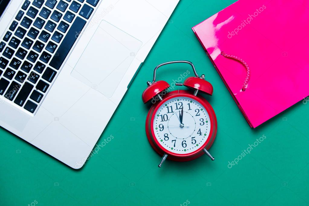 alarm clock, pink shopping bag 