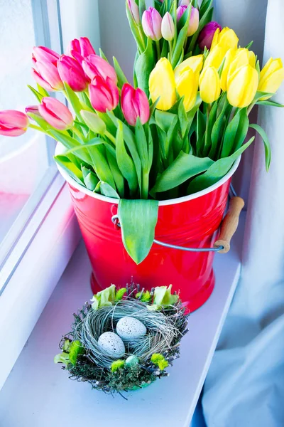 Tulips in bucket and eggs — Stock Photo, Image
