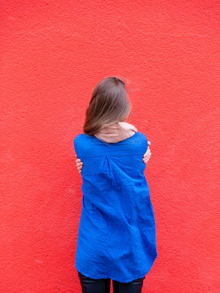 beautiful young woman hugging herself