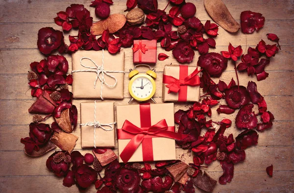 Gift boxes and red floral petals — Stock Photo, Image