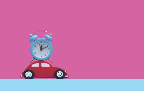 Red car toy and alarm clock — Stock Photo, Image