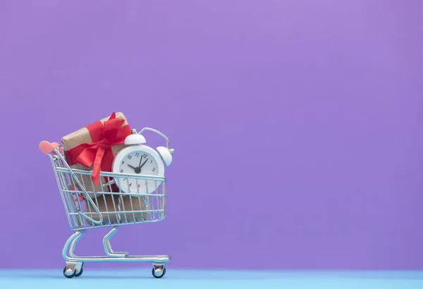 Gift boxes and alarm clock — Stock Photo, Image