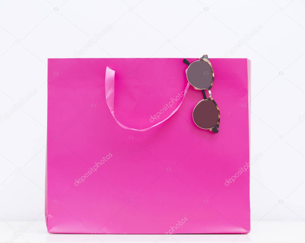 pink shopping bag and sunglasses 