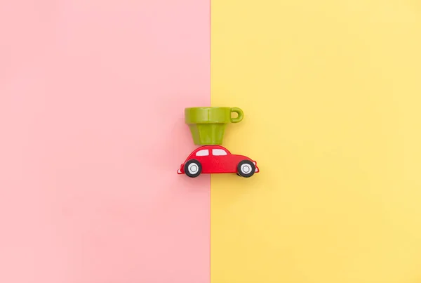 car shaped toy and empty cup