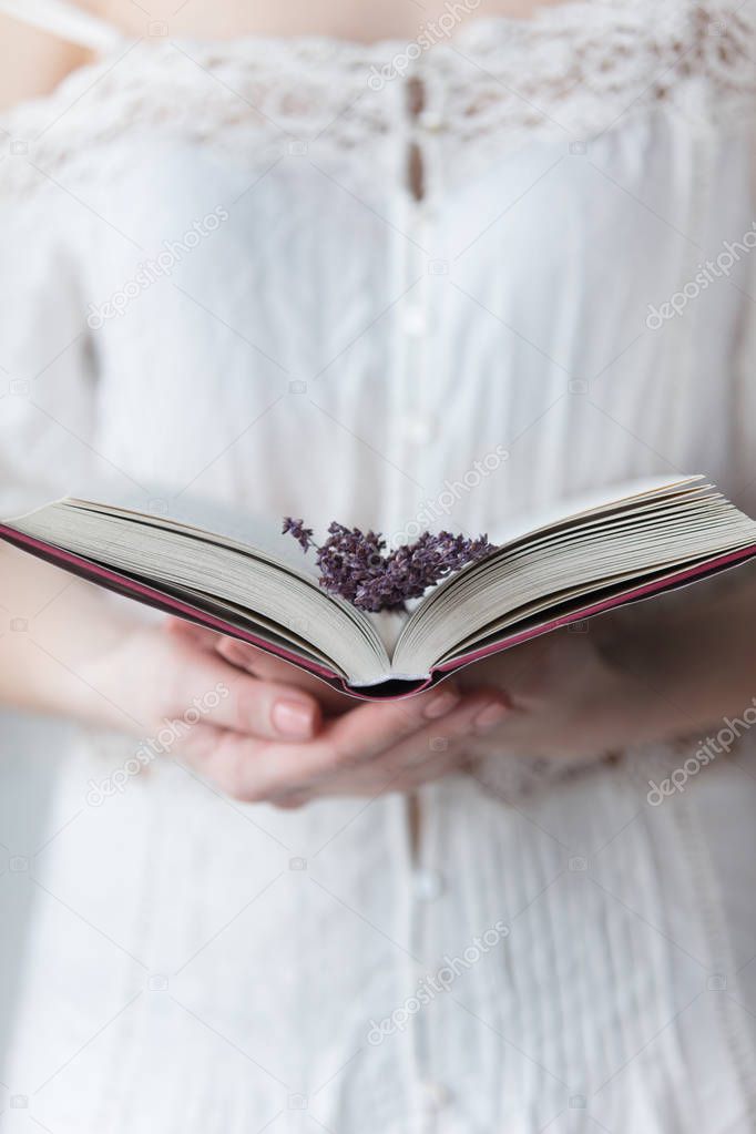 woman holding opened book