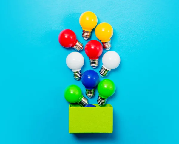 Colorful bulbs and green box — Stock Photo, Image