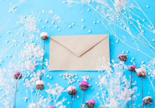 Craft paper envelope and flowers — Stock Photo, Image