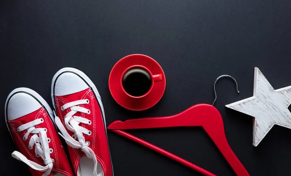 Red sporty gumshoes and cup of coffee — Stock Photo, Image